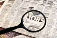 Image of black magnifying glass focused on a black and white newspaper ad that reads "JOBS"